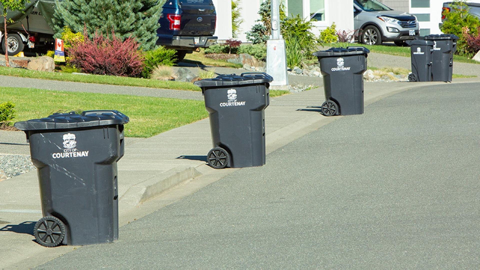 Courtenay collection bins lined up on the curb.