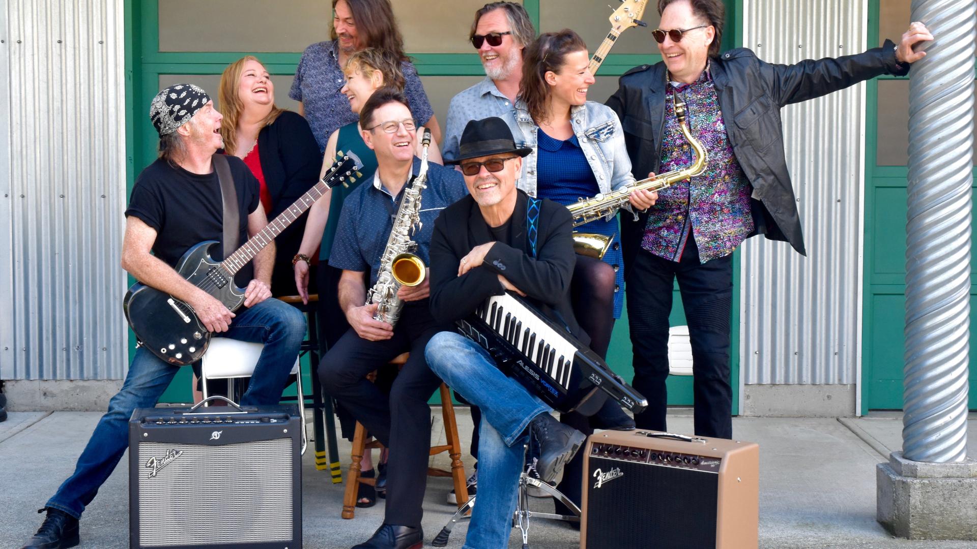 Stealing Dan band in front of a building having fun