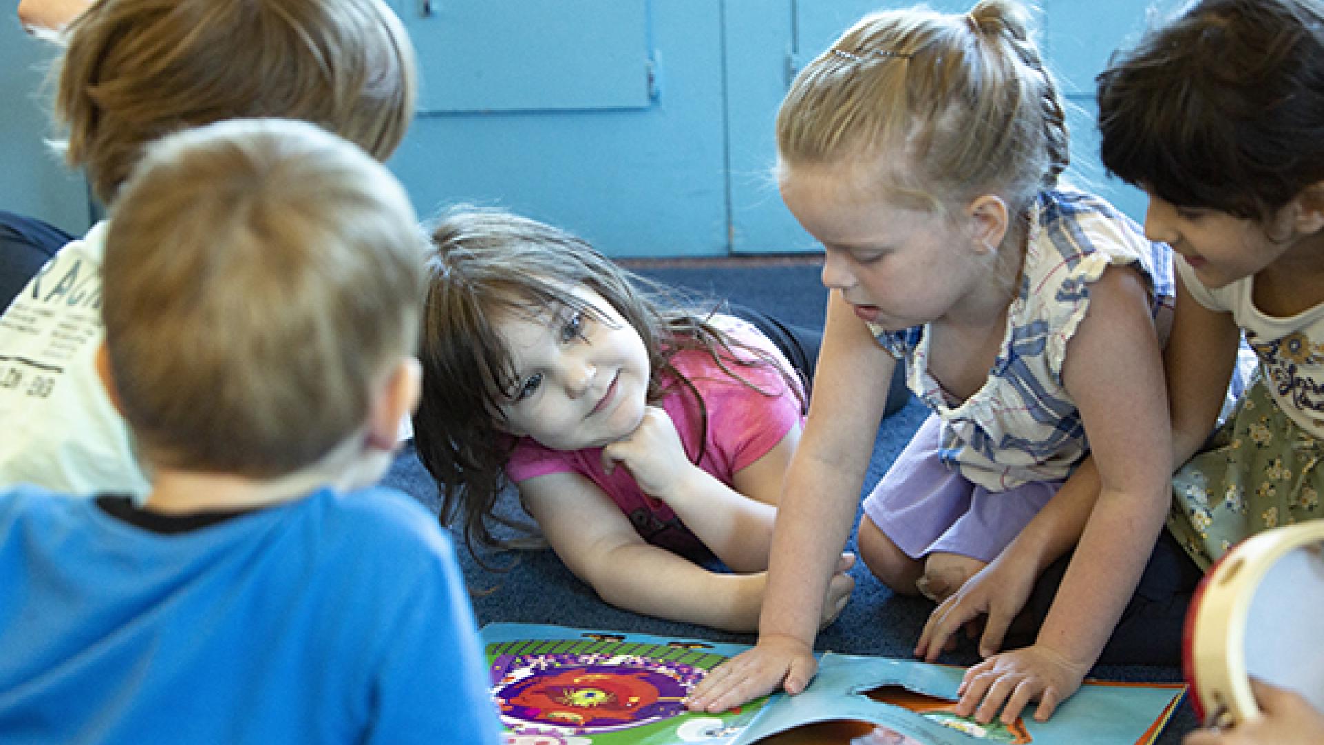 Kids viewing a book together