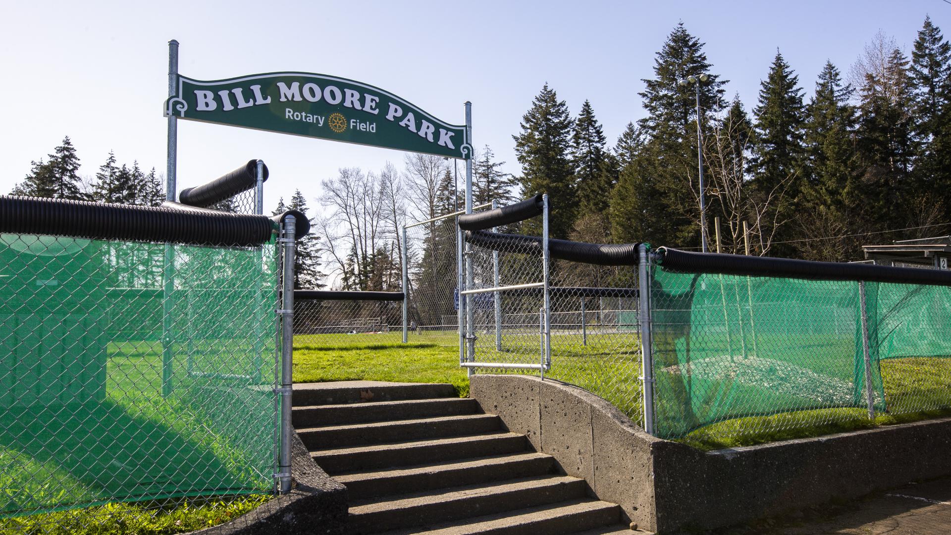 stairs leading to park with park name sign overhead