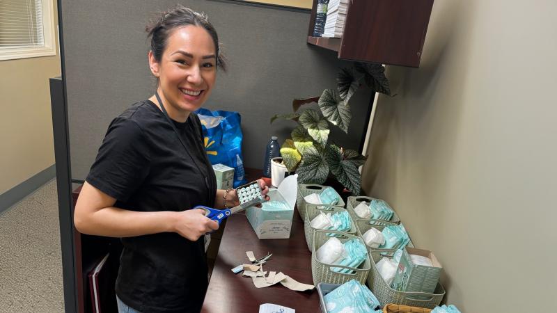 A City of Courtenay staff member prepares free menstrual products for City washrooms