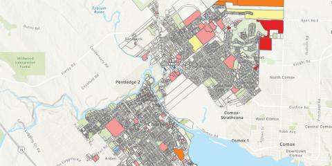 Color-coded development map showing land use in Courtenay and surrounding areas, including highlighted parcels for industrial, residential, commercial, and agricultural zoning.