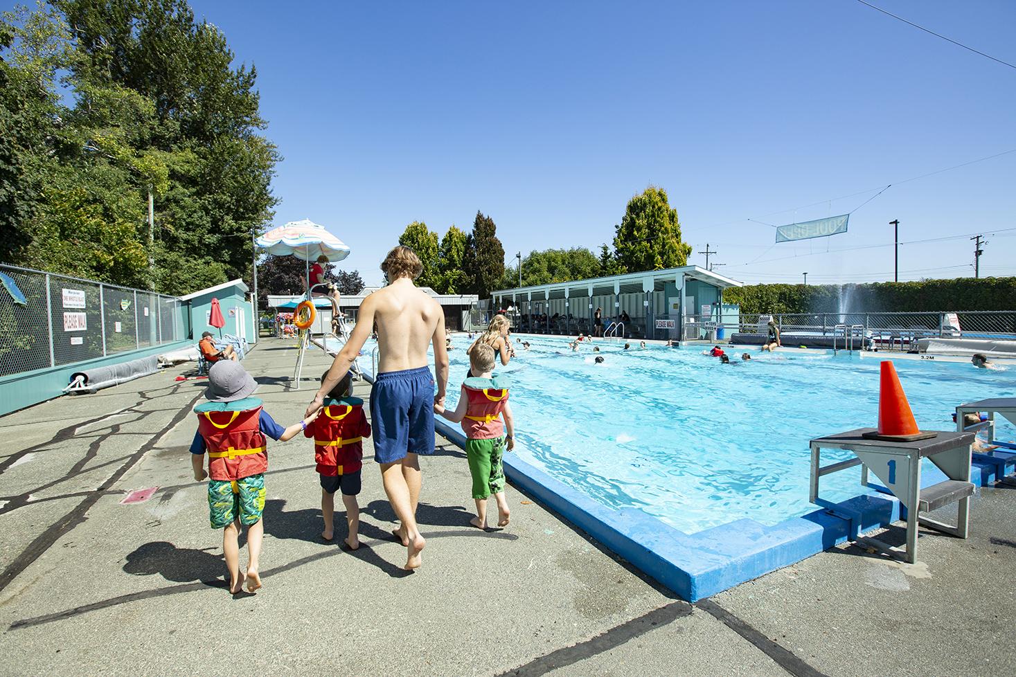 swim class walking beside pool